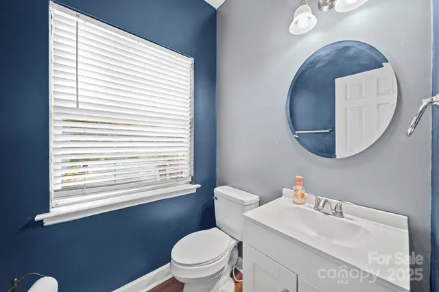 a bathroom with a toilet a sink and a mirror