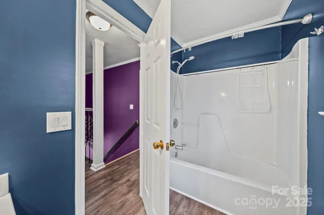 a bathroom with a bathtub and a shower