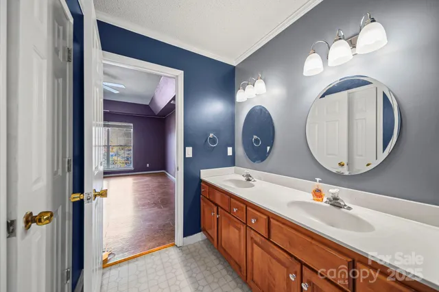 a bathroom with a double vanity sink and a mirror
