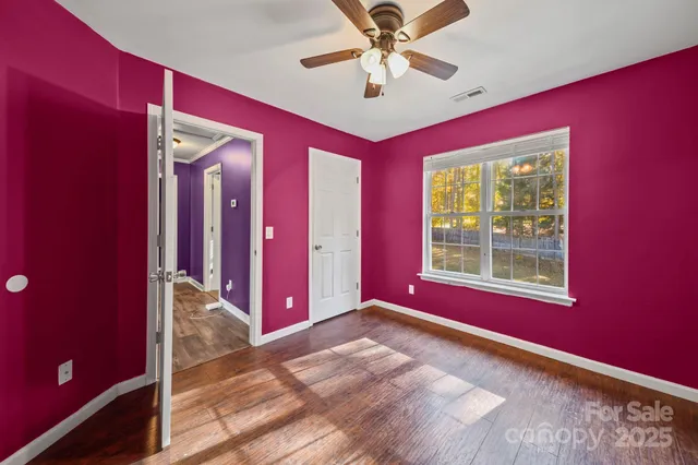 a view of a living room with hardwood floor and chandelier