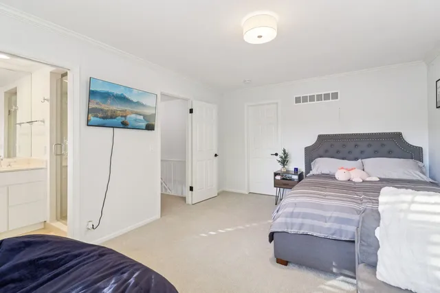a bathroom with a toilet a sink and a large mirror
