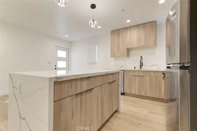 a kitchen with granite countertop a stove sink and cabinets