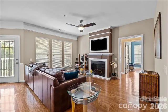 a living room with fireplace furniture and a flat screen tv