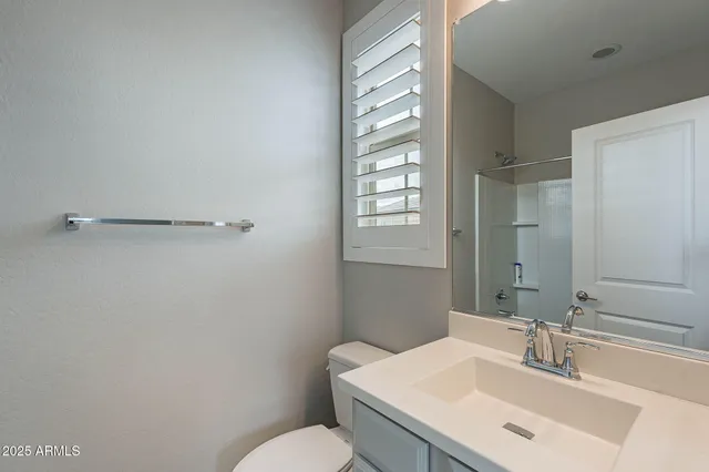 a bathroom with a sink toilet and vanity