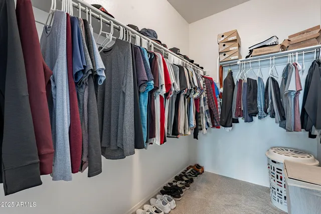 a view of walk in closet with clothes