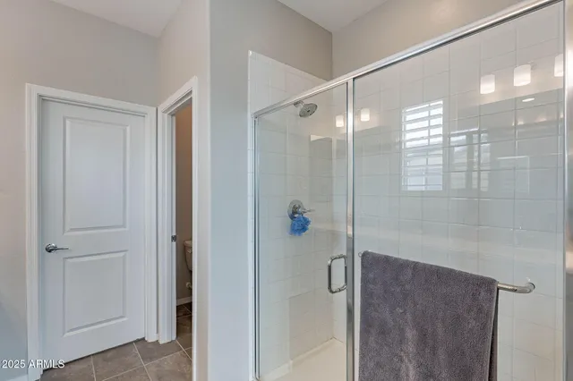 a bathroom with a glass shower door