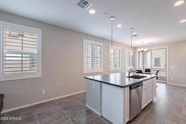 a kitchen with granite countertop sink stove and cabinets