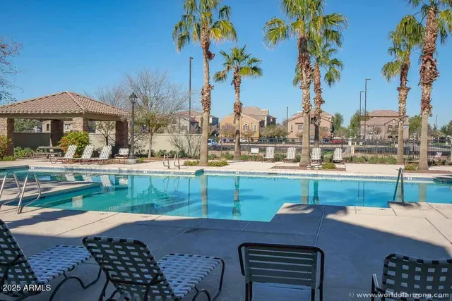 a backyard of a house with barbeque oven table and chairs