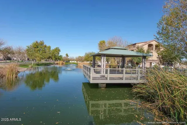 a view of a house with swimming pool next to a yard