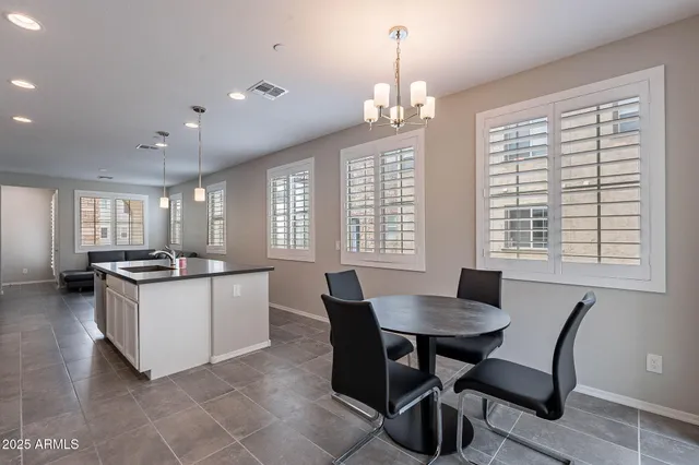 a kitchen with a dining table and chairs