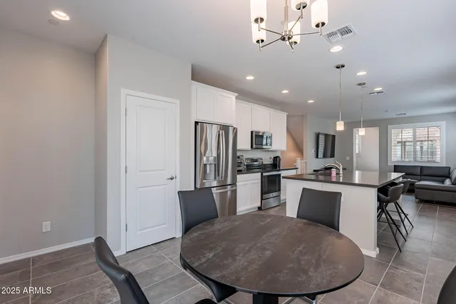 a large kitchen with a table and chairs in it