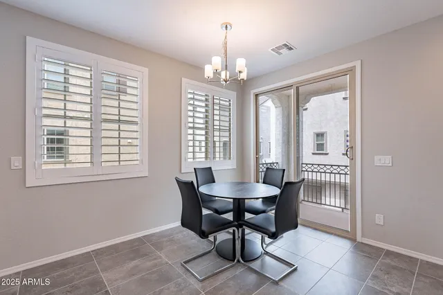 a view of a dining room with furniture and chandelier