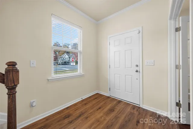 a view of empty room with wooden floor