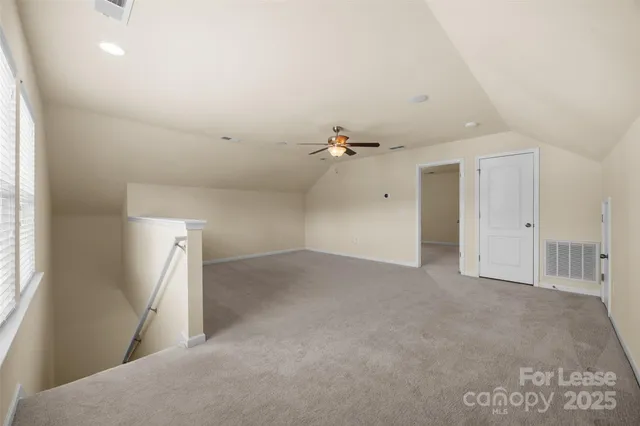 an empty room with a windows and dryer