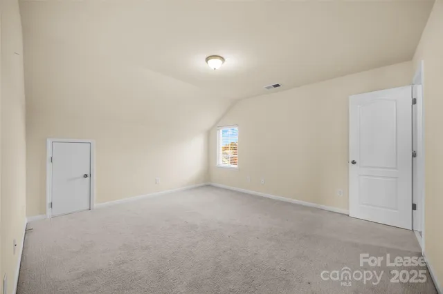 a view of an empty room and a window