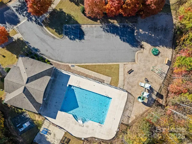 an aerial view of a house with a garden and parking space