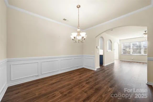a view of a room with wooden floor