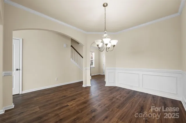 a view of a room with wooden floor and ceiling fan