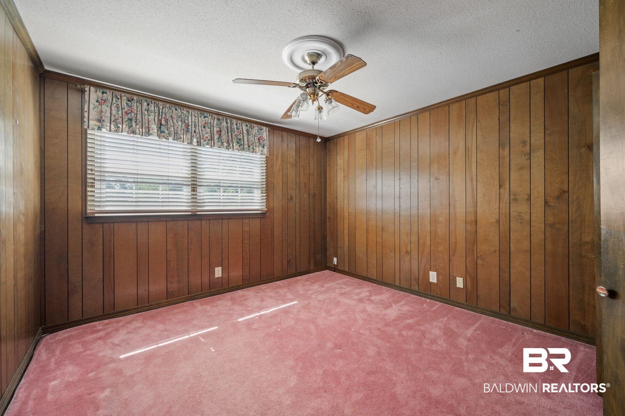 950 Walter Smith Road Mobile, AL 36695 - Photo 26 of 51 Carpeted empty room featuring a ceiling fan, wood walls, and a textured ceiling