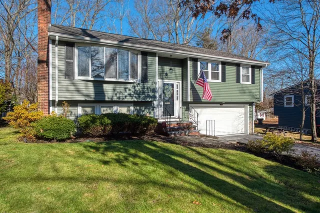 a front view of a house with a yard table and chairs