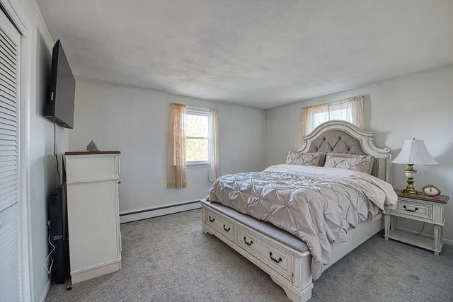 a bedroom with a bed and a tv