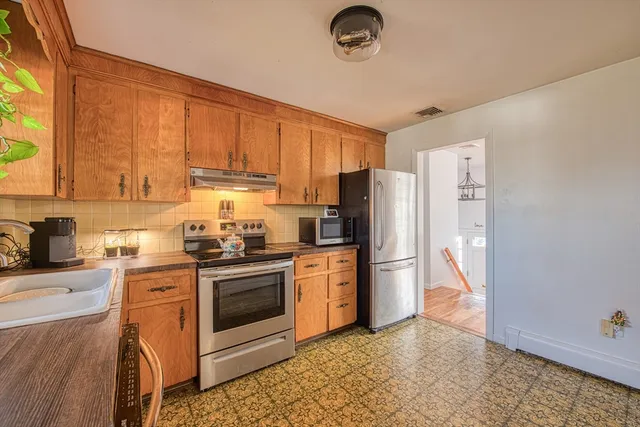 a kitchen with a stove sink and refrigerator