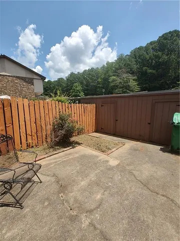 a view of backyard with wooden fence