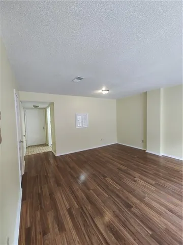 a view of an empty room and wooden floor