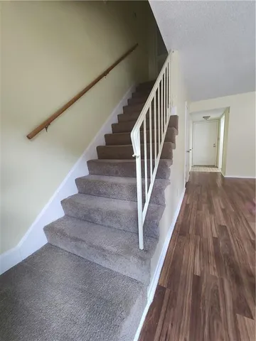 a view of entryway and hall with wooden floor