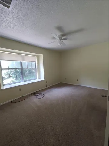 an empty room with a empty space and windows