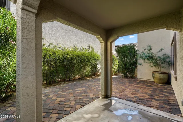 a view of a porch with potted plants