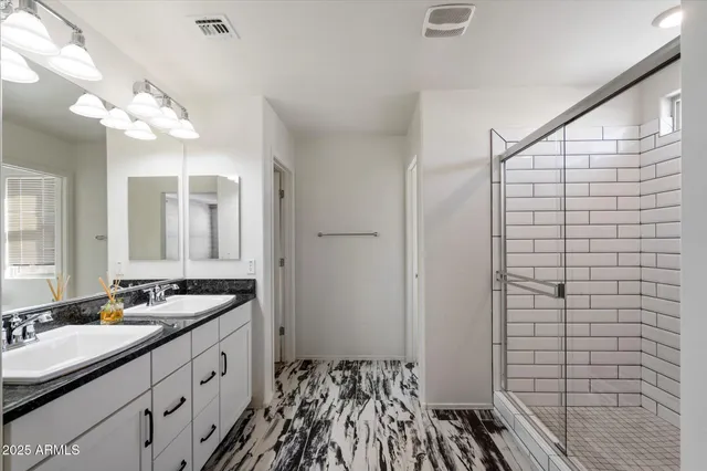 a bathroom with a double vanity sink and mirror