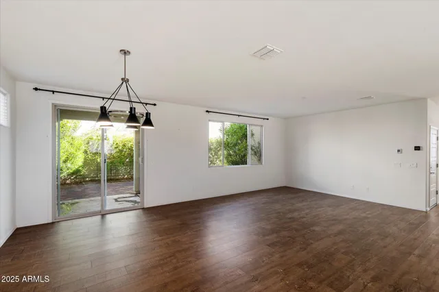 a view of a room with wooden floor and windows