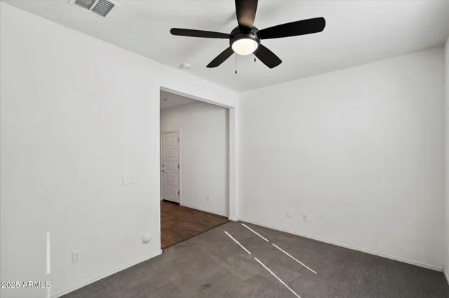 an empty room with a ceiling fan and a ceiling fan