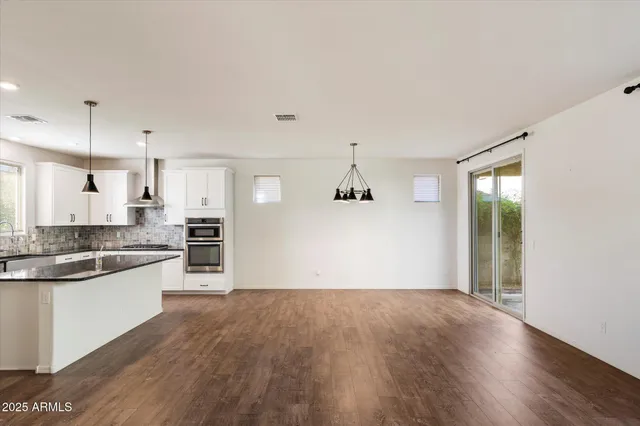 a view of kitchen with wooden floor and electronic appliances