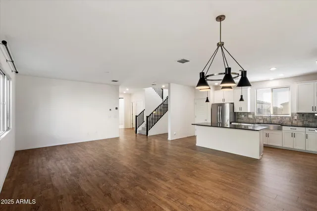 a view of a room with wooden floor windows and a chandelier