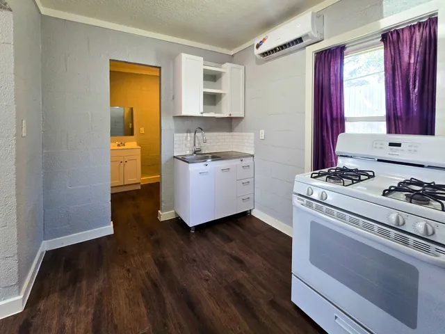 a kitchen with a stove a sink and a refrigerator