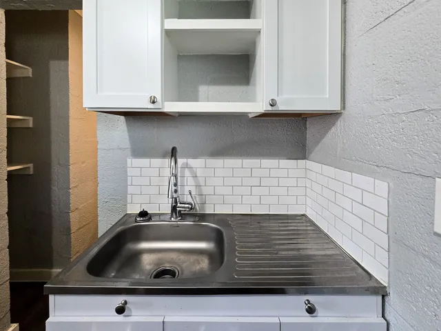a kitchen with a sink and cabinets