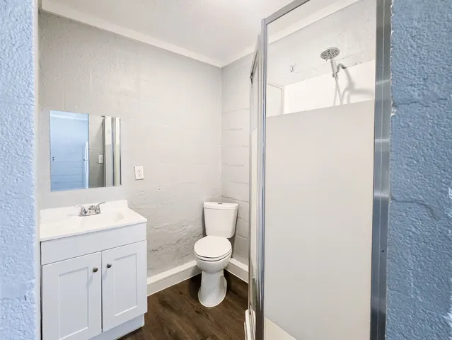 a bathroom with a toilet sink and mirror
