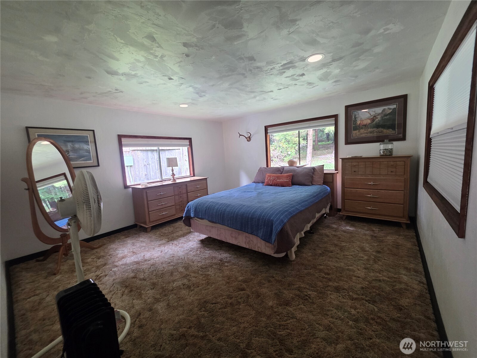 540 Nichols Road Clallam Bay, WA 98326 - Photo 11 of 25 a bedroom with a bed a mirror on dresser and a window