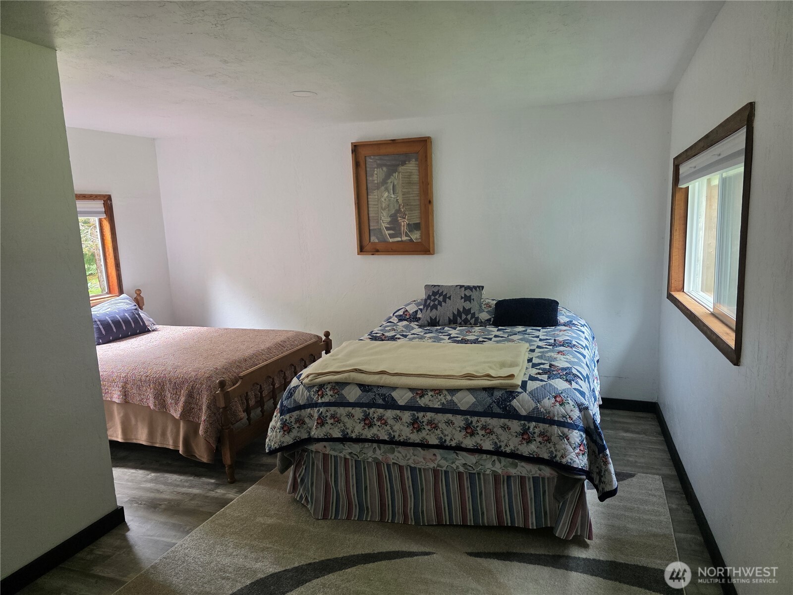 540 Nichols Road Clallam Bay, WA 98326 - Photo 13 of 25 a bedroom with a bed and wooden floor