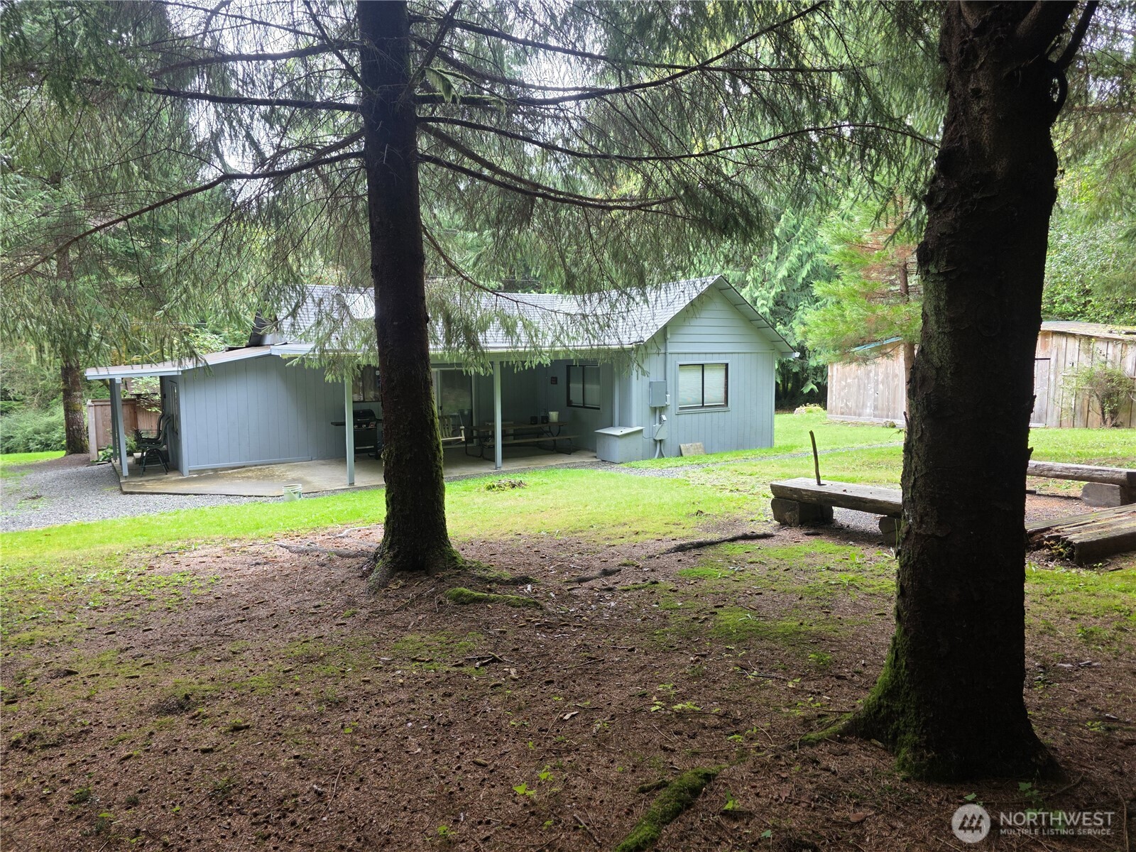 540 Nichols Road Clallam Bay, WA 98326 - Photo 2 of 25 a view of a house with backyard and a tree