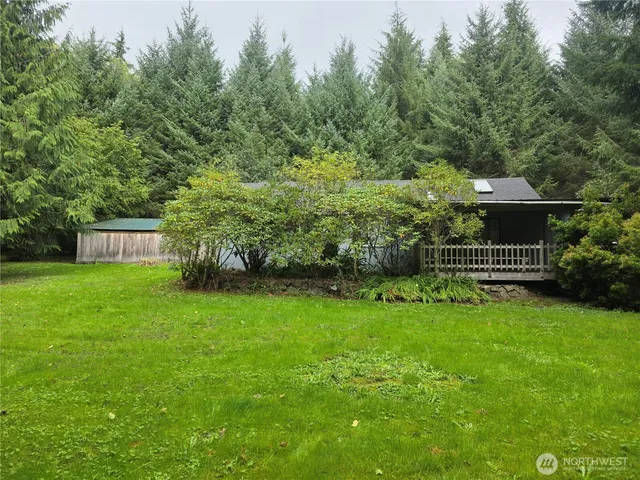 a view of a garden with house in the background
