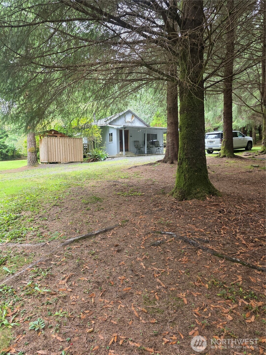 540 Nichols Road Clallam Bay, WA 98326 - Photo 3 of 25 a white house that has a tree in front of it