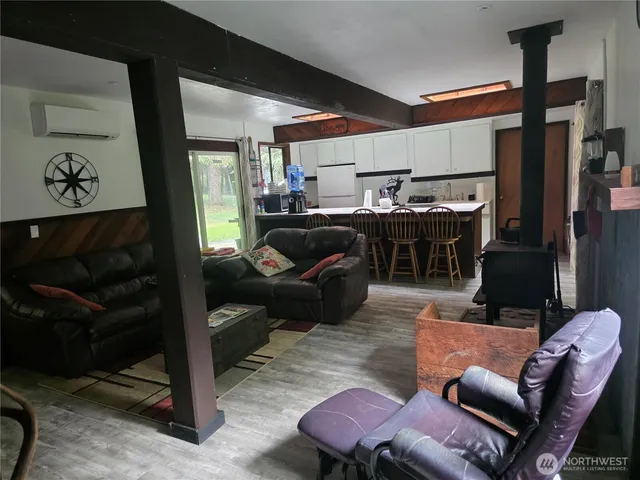 a living room with furniture a ceiling fan and a rug