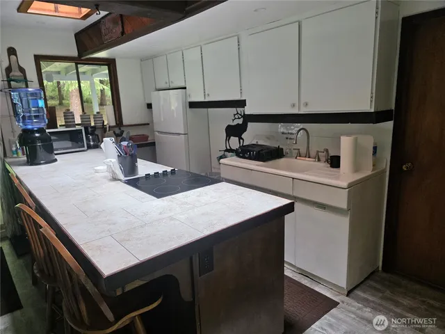 a kitchen with sink cabinets and chair