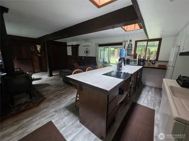 a kitchen with a table chairs and a wooden floor