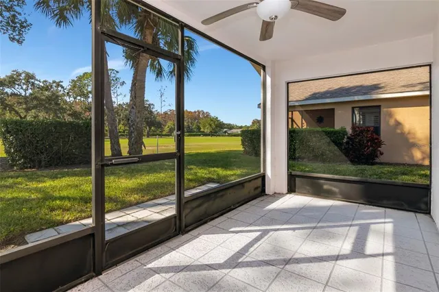 a view of a glass door with a floor to ceiling window next to a yard