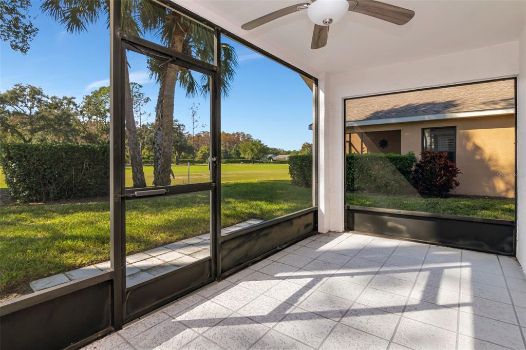 9500 Green Needle Drive New Port Richey, FL 34655 - Photo 14 of 28 a view of a glass door with a floor to ceiling window next to a yard