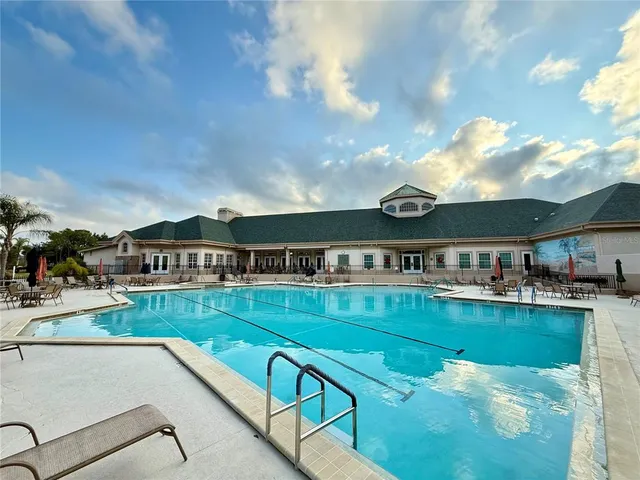 a view of a swimming pool with a yard